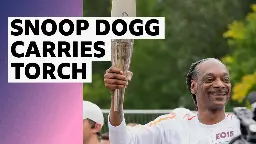 Rapper Snoop Dogg carries Olympic torch through Paris